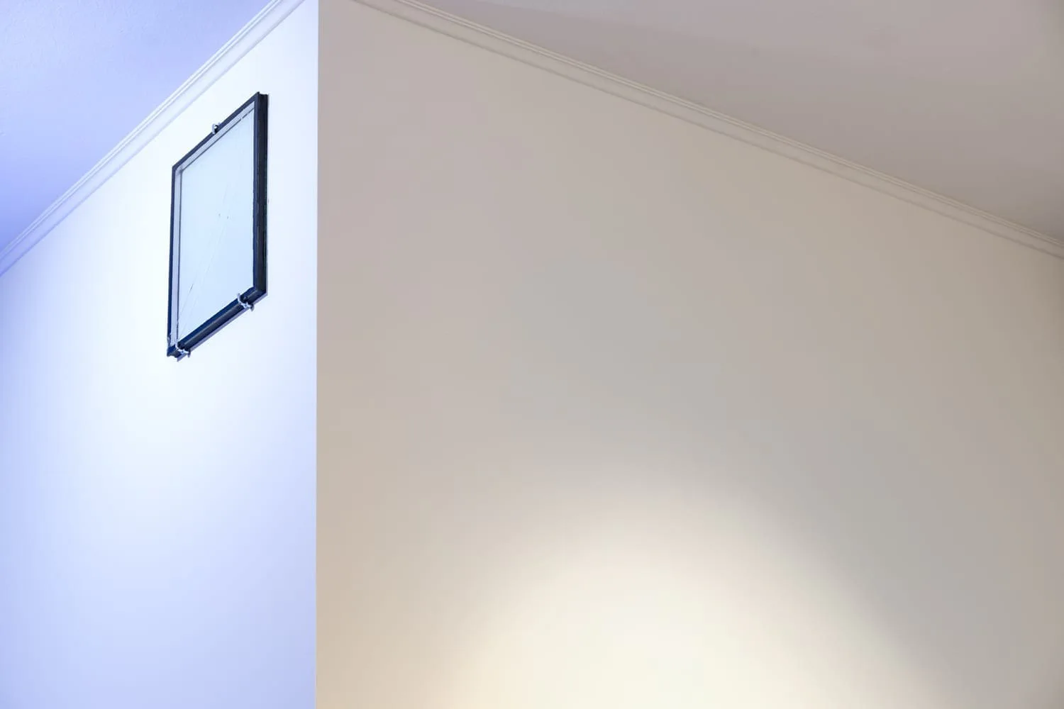Michal Martychowiec, The incredulity of Saint Thomas, 2015/2020: small frame high on a wall next to blue light