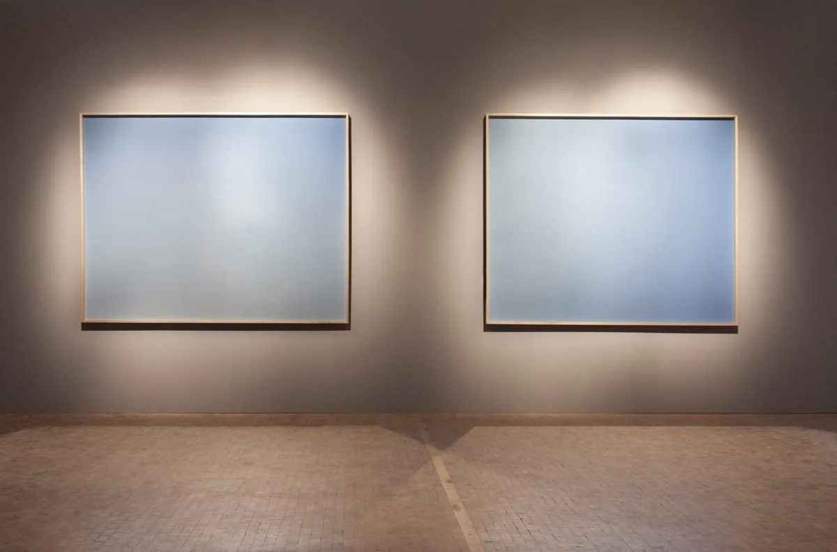Installation view: two large pale blue pictures side by side on a wall