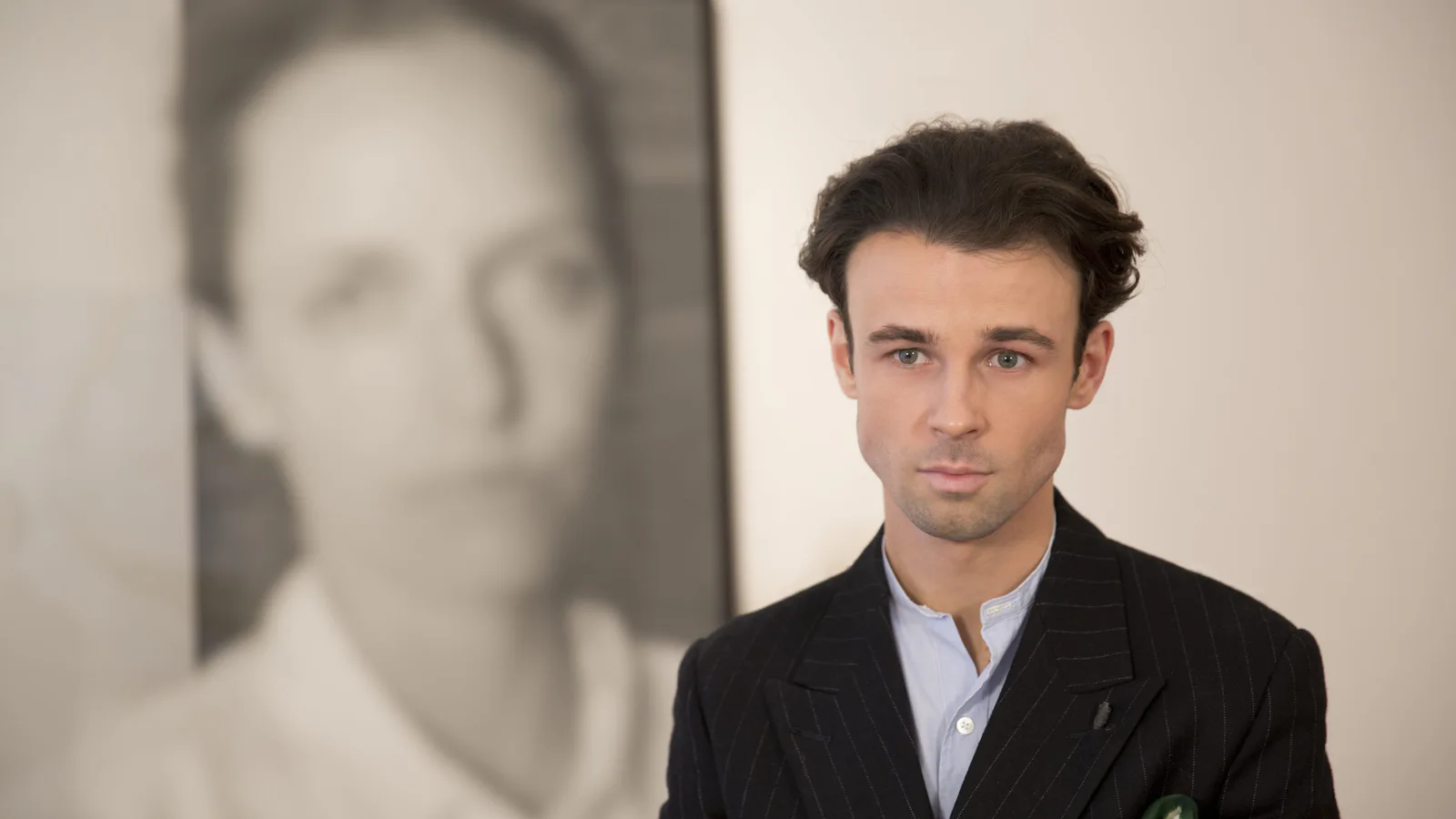 Michal Martychowiec talking to the Chinese television channel CCTV, a portrait in the background