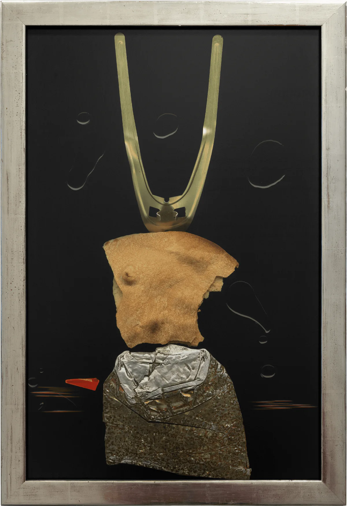Hilarion Manero, Odyssos, 1998: collage on a black ground with a torso and a metal fork in a silver frame
