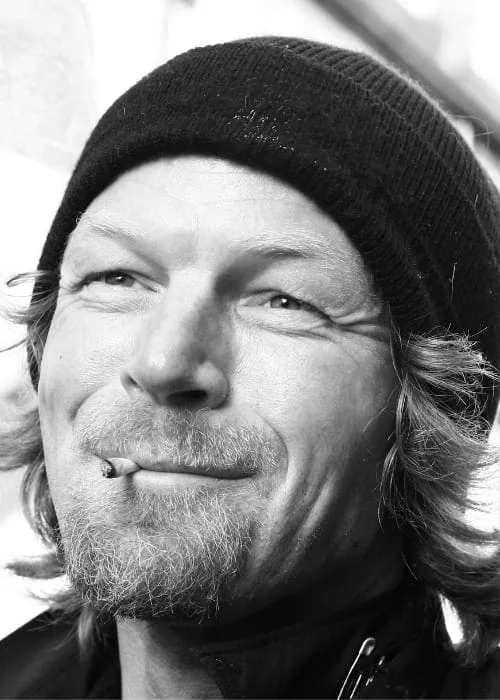 Portrait of Gabriel (E. W. Moes) wearing a beanie and smoking a cigarette, black and white