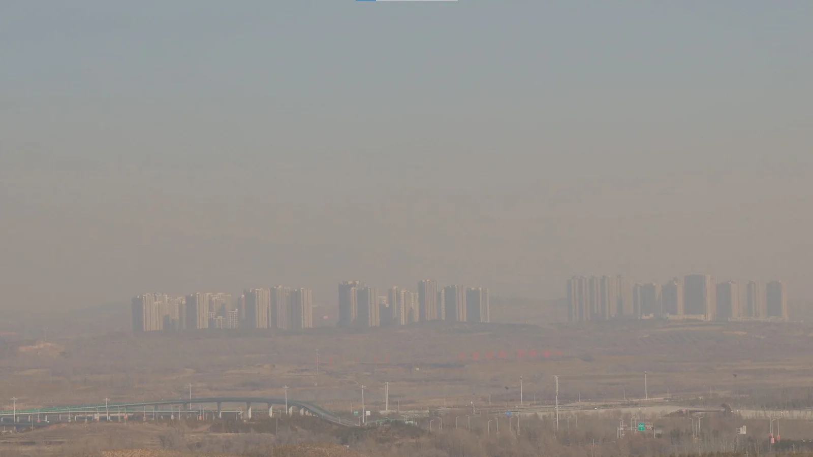 Michal Martychowiec: high-rise buildings on the horizon in the haze of a flat landscape