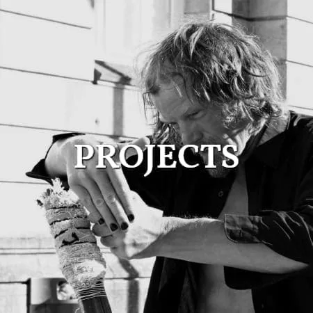 Mnemosyne Projects: a man holding a decorated scroll in his hands, black and white, title lettering over the image