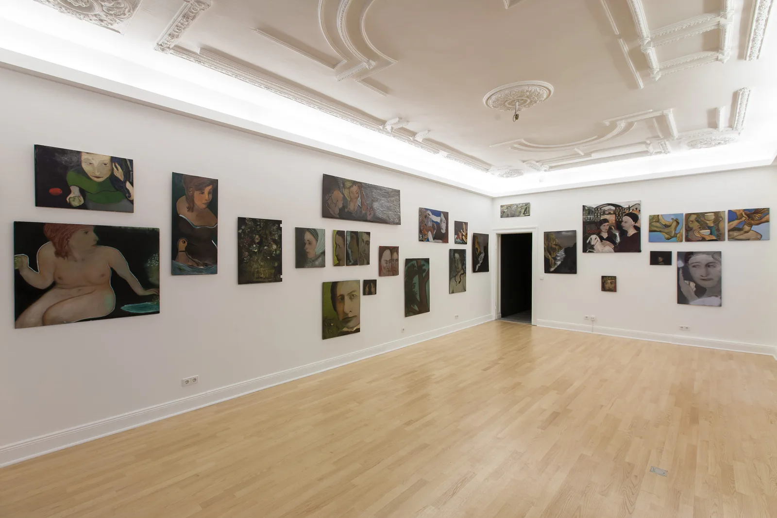 Installation view: period hall with stucco ceiling, parquet and many paintings by Hilarion Manero on the walls
